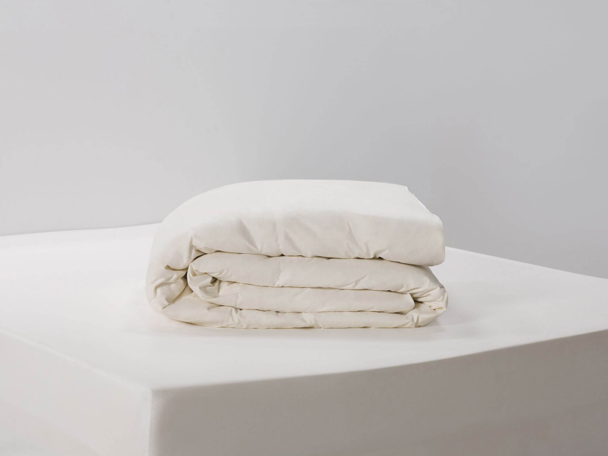 Front view of folded ivory down duvet